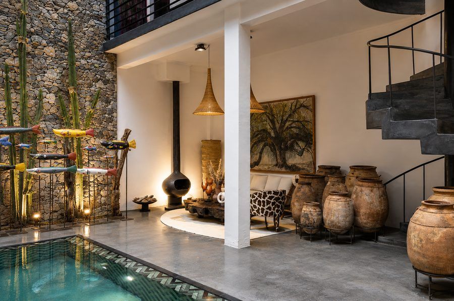 A courtyard styled with Moroccan rugs and terracotta pieces from the Soufiane Zarib collection